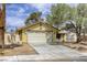 Attractive home showcasing a two-car garage, well-manicured landscaping, and a welcoming curb appeal at 1012 Winwood St, Las Vegas, NV 89108