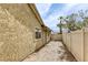 Exterior view showcasing the side of the house with textured walls, gravel landscaping, and privacy fencing at 1012 Winwood St, Las Vegas, NV 89108