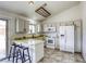 Bright kitchen features white cabinets and appliances, and a breakfast bar at 1012 Winwood St, Las Vegas, NV 89108