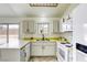 Corner kitchen features white cabinets, appliances, and backyard access at 1012 Winwood St, Las Vegas, NV 89108