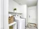 Functional laundry room with a modern washer and dryer, shelving and neutral colors at 1012 Winwood St, Las Vegas, NV 89108