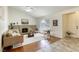 Cozy living room features a brick fireplace, ceiling fan, and a bright window at 1012 Winwood St, Las Vegas, NV 89108