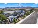 An aerial view of a contemporary home showcases its modern architecture and is nestled in a neighborhood near desert mountains at 10297 Sierra Skye Ave, Las Vegas, NV 89166