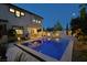 Backyard with an inviting pool featuring underwater lighting, travertine decking, and outdoor dining area at 10297 Sierra Skye Ave, Las Vegas, NV 89166