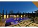 Inviting backyard pool featuring stylish in-pool loungers, lush landscaping, and a stainless steel grill at 10297 Sierra Skye Ave, Las Vegas, NV 89166
