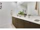 Bathroom vanity featuring double sinks, modern cabinetry, and a large mirror at 10297 Sierra Skye Ave, Las Vegas, NV 89166