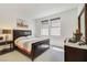Relaxing bedroom with a comfortable bed, dresser, and ample natural light from two windows at 10297 Sierra Skye Ave, Las Vegas, NV 89166