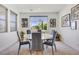 Elegant dining room with a round table, comfortable seating, and natural light from the window at 10297 Sierra Skye Ave, Las Vegas, NV 89166