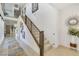 Bright foyer with high ceilings, modern staircase, and elegant decor creates an inviting entry to the home at 10297 Sierra Skye Ave, Las Vegas, NV 89166