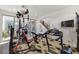 Home gym with treadmill, weight machines, and natural light from sliding glass doors at 10297 Sierra Skye Ave, Las Vegas, NV 89166