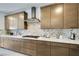 Well-equipped kitchen features ample counter space, custom cabinetry, and stainless steel range hood at 10297 Sierra Skye Ave, Las Vegas, NV 89166