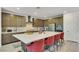 Modern kitchen with a large center island, counter seating, stainless steel appliances, and stylish backsplash at 10297 Sierra Skye Ave, Las Vegas, NV 89166