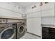 Spacious laundry room with front-loading washer and dryer and ample storage at 10297 Sierra Skye Ave, Las Vegas, NV 89166