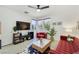 Open-concept living room with comfortable seating, a modern TV, and bright windows at 10297 Sierra Skye Ave, Las Vegas, NV 89166