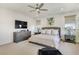 Elegant main bedroom with neutral decor, soft lighting, and a ceiling fan at 10297 Sierra Skye Ave, Las Vegas, NV 89166