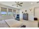 Serene main bedroom with natural light, comfortable seating, and modern ceiling fan at 10297 Sierra Skye Ave, Las Vegas, NV 89166