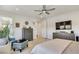 Bright main bedroom with comfortable seating, modern decor, and a ceiling fan at 10297 Sierra Skye Ave, Las Vegas, NV 89166