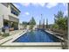 A pristine pool provides a refreshing oasis in this backyard, complemented by lush greenery and lounge area at 10297 Sierra Skye Ave, Las Vegas, NV 89166