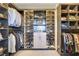Spacious walk-in closet with custom shelving for clothes and shoes, and cabinets for storage at 10297 Sierra Skye Ave, Las Vegas, NV 89166