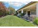 Expansive backyard showcasing a covered patio, lush green lawn, privacy landscaping, and meticulously maintained grounds at 10404 Stanberry Ave, Las Vegas, NV 89135