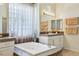 Relaxing bathroom showcasing a soaking tub, window, and decorative accents at 10404 Stanberry Ave, Las Vegas, NV 89135