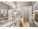 Elegant bathroom with dual sinks, granite counters, and framed mirrors at 10404 Stanberry Ave, Las Vegas, NV 89135
