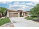 Charming single-story home with a well-manicured lawn and three-car garage, embodying suburban elegance at 10404 Stanberry Ave, Las Vegas, NV 89135