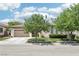 Inviting single-story home showcasing mature trees and a pristine lawn, offering a serene street view at 10404 Stanberry Ave, Las Vegas, NV 89135