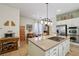 Open kitchen featuring stainless appliances, an island with gas cooktop, granite countertops, and a breakfast bar at 10404 Stanberry Ave, Las Vegas, NV 89135