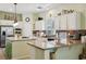 Open kitchen with stainless appliances, island with bar seating, granite countertops, and a tile backsplash at 10404 Stanberry Ave, Las Vegas, NV 89135