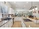 Spacious kitchen with stainless appliances, granite countertops, double sink, and a tile backsplash at 10404 Stanberry Ave, Las Vegas, NV 89135
