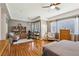 Large main bedroom with seating area, hardwood flooring, ample windows, and neutral paint color at 10404 Stanberry Ave, Las Vegas, NV 89135