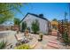 Landscaped backyard with seating, trees, and brick-lined pathways for a serene retreat at 108 Verdy Ln, Las Vegas, NV 89101
