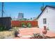 Charming backyard with brick fence, seating, and a view of the Circa hotel in the distance at 108 Verdy Ln, Las Vegas, NV 89101