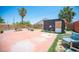 Spacious backyard with concrete patio, modern fence, shed, desert plants, and ample space for outdoor enjoyment at 108 Verdy Ln, Las Vegas, NV 89101