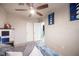Bedroom with painted brick walls, ceiling fan, and open doors at 108 Verdy Ln, Las Vegas, NV 89101
