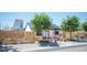 Inviting single-story home with a metal roof, modern fence, and desert-friendly landscaping at 108 Verdy Ln, Las Vegas, NV 89101