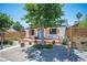 Front exterior featuring desert landscaping, modern fencing, and seating area on the charming porch at 108 Verdy Ln, Las Vegas, NV 89101