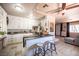 Modern kitchen features white cabinetry, tile floors, and island with seating and lots of natural light at 108 Verdy Ln, Las Vegas, NV 89101