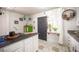 Kitchen island with sink, view to back entry, and plants decorating the space at 108 Verdy Ln, Las Vegas, NV 89101