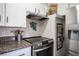 A stainless steel oven sits beneath an exhaust fan in this kitchen at 108 Verdy Ln, Las Vegas, NV 89101