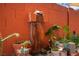 Unique water feature on a brick wall surrounded by lush potted plants at 108 Verdy Ln, Las Vegas, NV 89101