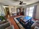 Comfortable living room featuring tile flooring, ceiling fan, and sliding glass doors to the backyard at 109 Prince Ln, Las Vegas, NV 89110