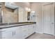Bathroom featuring dual sinks, modern fixtures, and a separate tiled shower area for a luxurious experience at 10985 Limeslice Ave # 2, Las Vegas, NV 89135