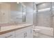 Bathroom featuring a large vanity with double sinks, tiled floors, and a shower-tub combination with gray tiling at 10985 Limeslice Ave # 2, Las Vegas, NV 89135