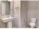 Neutral powder room features pedestal sink, toilet, and tiled floors at 10985 Limeslice Ave # 2, Las Vegas, NV 89135