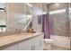 Modern bathroom features shower/tub combo with gray tiled walls, and white quartz countertops at 10985 Limeslice Ave # 2, Las Vegas, NV 89135