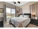 Cozy main bedroom features a large window providing lots of natural light and peaceful views at 10985 Limeslice Ave # 2, Las Vegas, NV 89135