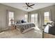 Large, bright bedroom features a ceiling fan and an attached balcony for enjoying the views at 10985 Limeslice Ave # 2, Las Vegas, NV 89135