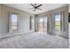 Spacious bedroom with carpet, large windows, and a sliding glass door offering natural light and views at 10985 Limeslice Ave # 2, Las Vegas, NV 89135